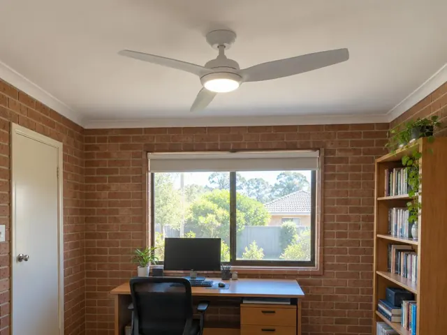 Ceiling fan with light in a brick-walled home office with window and desk in Lake Munmorah